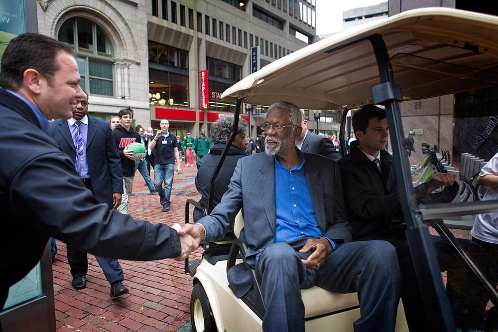 Russell shakes hands with a fan on his way to the statue dedication ceremony at the State Room. (Jesse Costa/WBUR)