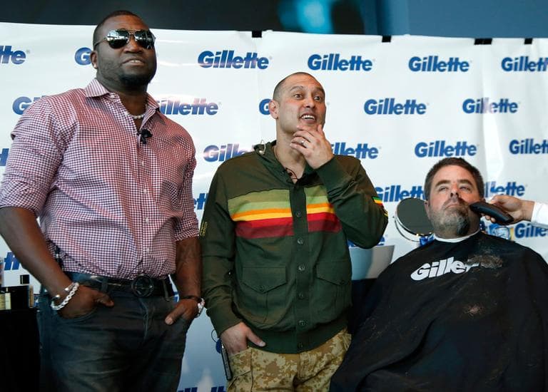 Boston Police Officer Steve Horgan is shaved as Sox players David Ortiz, left, and Shane Victorino look on during a shave-off for the One Fund on Monday. (Elise Amendola/AP)