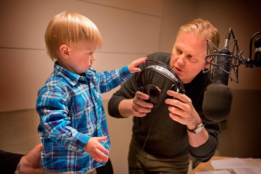 On Point host Tom Ashbrook meets a young fan, Nolan, in the WBUR studios. (WBUR)