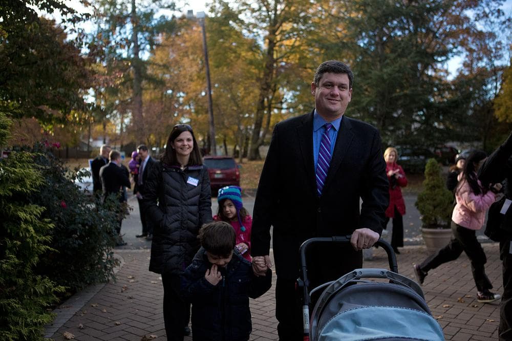 John Connolly and his wife, Meg Kassakian Connolly, walk to their polling place in West Roxbury. (Jesse Costa/WBUR)