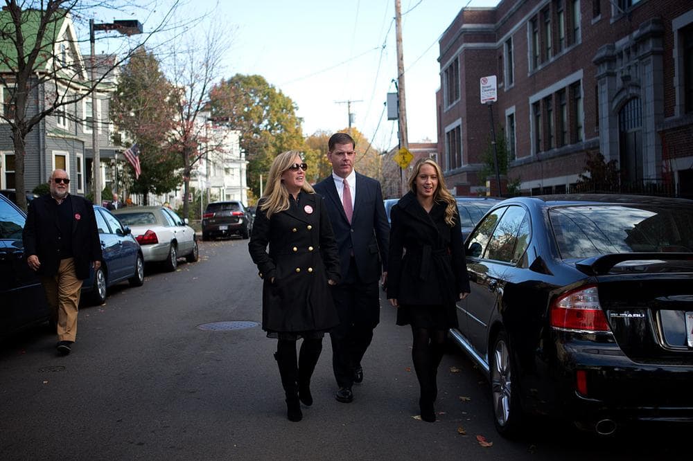Mayoral candidate Marty Walsh, with his longtime partner Lorrie Higgins and her daughter Lauren, head into the Cristo Rey School in Savin Hill to cast their ballots. (Jesse Costa/WBUR)