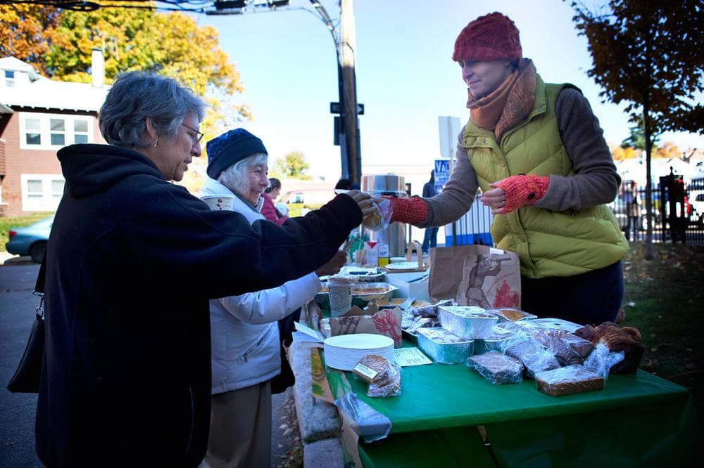 Andrea and Ruth Tamkin grab a snack from a bake sale after voting at the Curley School in Jamaica Plain. (Jesse Costa/WBUR)