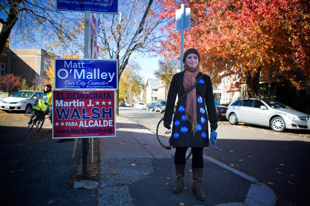 Naomi D’Ottavio, of Brighton, shows her support for Boston City Council candidate Jeff Ross outside the Curley School in Jamaica Plain. (Jesse Costa/WBUR)