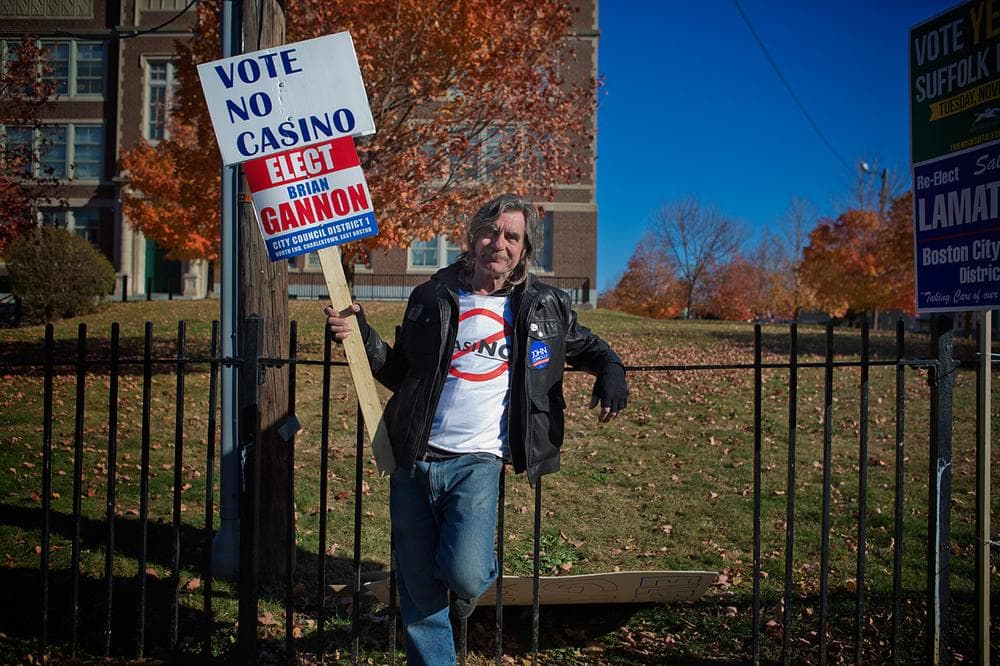 East Boston resident George Kougeas holds a “no casino” sign outside East Boston High School. (Jesse Costa/WBUR)