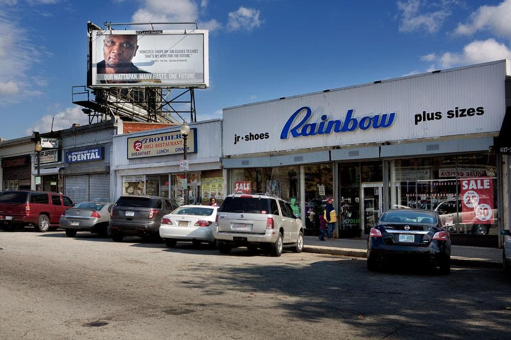 Tony “Big Time” Seymore’s photo on a billboard over Mattapan Square is part of the $2 million campaign aiming to reduce gun violence and support high-risk youth and families. (Jesse Costa/WBUR)