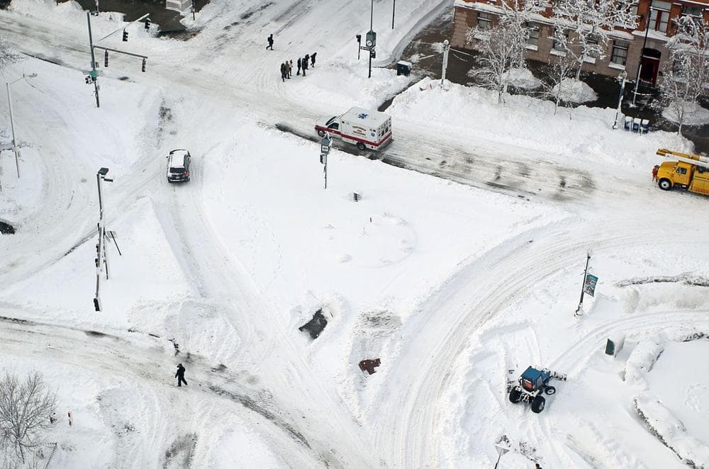 An ambulance drives through downtown Providence, R.I., as crews work to clear the roads after winter storm Nemo in February 2013. (Stew Milne/AP)