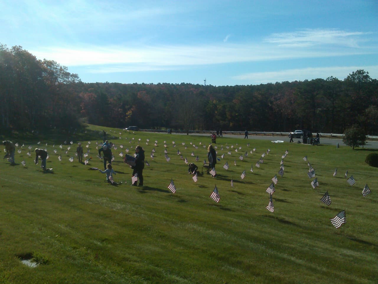 More than 2,000 people planted flags by graves at the Massachusetts National Cemetery on Cape Cod on November 9, 2013 for Veteran's Day. (Alex Ashlock/Here & Now)