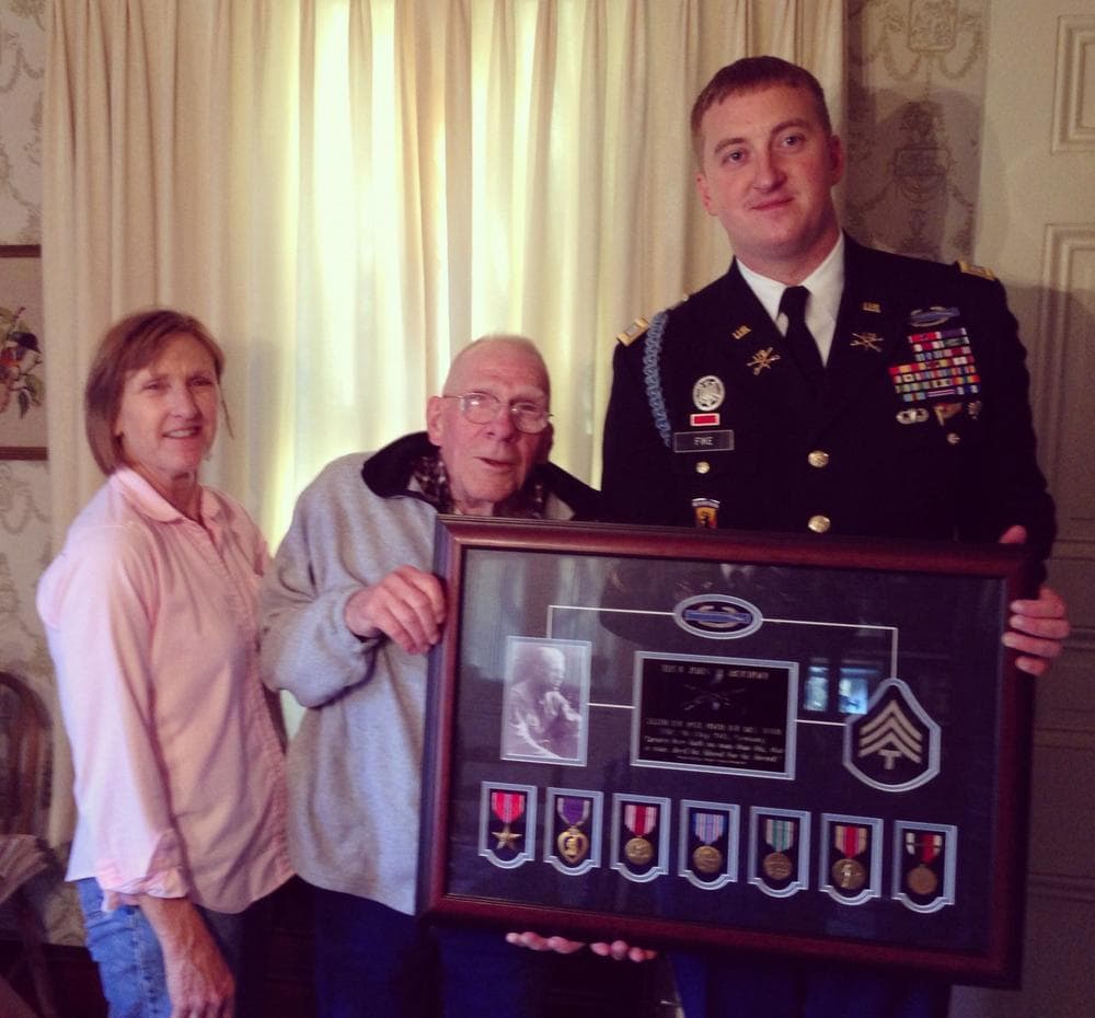 Zachariah Fike (right) returns a Purple Heart to SSG John Bischoff, a WWII and Korea veteran, Nov. 10, 2013, in Bowie, MD. His Purple Heart was stolen from his home two years ago. (Purple Hearts United)