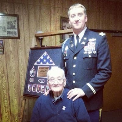 Zachariah Fike (right) returns a Purple Heart to the brother of SSG Robert Capper, Nov. 8, 2013, in Cliffton Park, N.Y. Capper was wounded in WWII on Oct. 20, 1944. (Purple Hearts United)