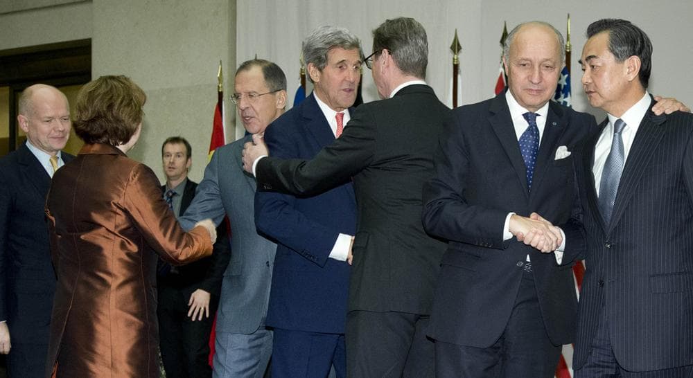 A deal has been reached between six world powers and Iran that calls on Tehran to limit its nuclear activities in return for sanctions relief. In this photo, from left, British Foreign Secretary William Hague, EU foreign policy chief Catherine Ashton, Russia's Foreign Minister Sergey Lavrov, U.S. Secretary of State John Kerry, Germany's Foreign Minister Guido Westerwelle, French Foreign Minister Laurent Fabius and Chinese Foreign Minister Wang Yi, shake hands after Ashton read a statement to the media at the United Nations Palais, Sunday, Nov. 24, 2013, in Geneva, Switzerland. (Carolyn Kaster/AP, Pool)