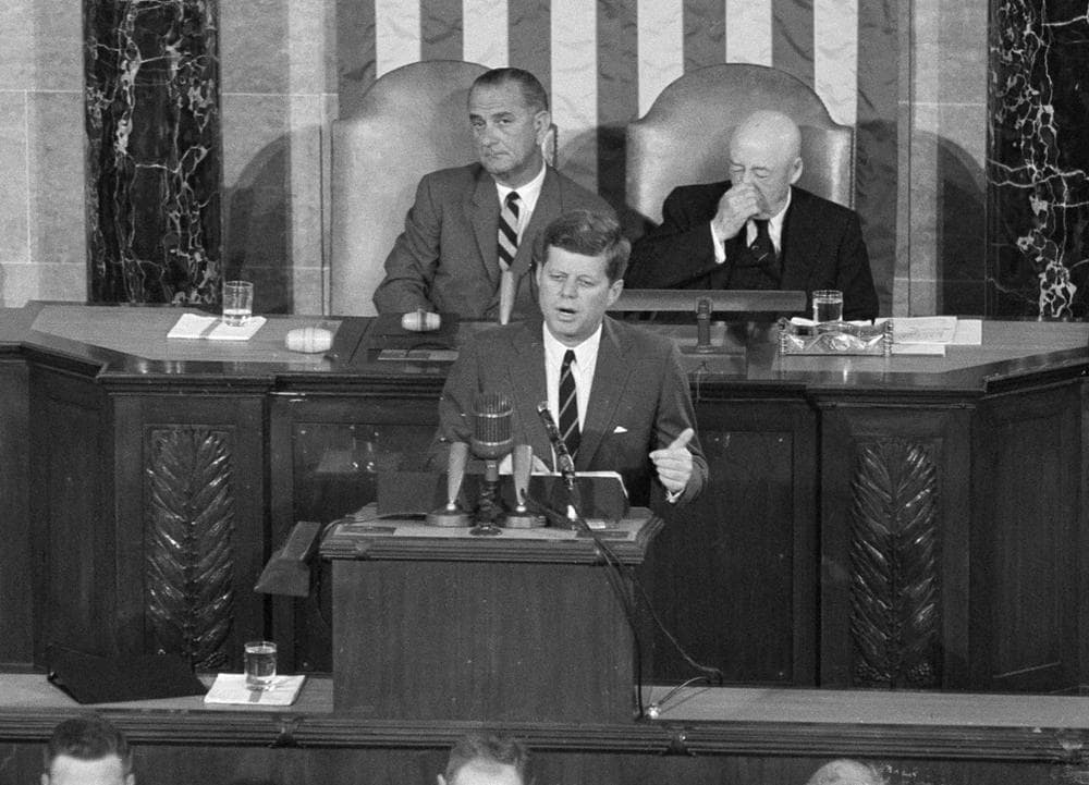 In this May 25, 1961, file photo, President John F. Kennedy speaks in the House of Representatives before a joint session of Congress in Washington. In the background are Vice President Lyndon B. Johnson and House Speaker Sam Rayburn. During the address, Kennedy issued the challenge, ". . .I believe that this nation should commit itself to achieving the goal, before this decade is out, of landing a man on the Moon and returning him safely to the Earth." (AP Photo, File)