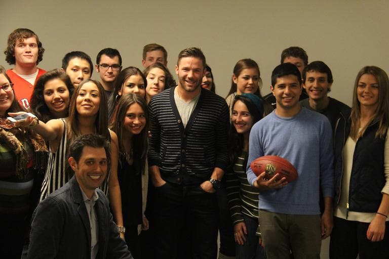 New England Patriots wide receiver Julian Edelman (center) visited a social media marketing class taught by David Gerzof Richard (front kneeling) at Emerson College in Boston this fall. (Courtesy of Maya Rafie/Emerson College) 