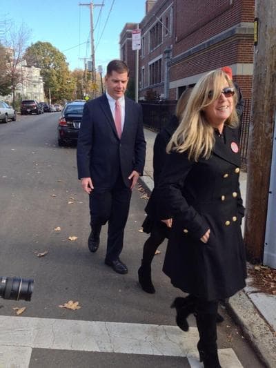 Mayoral candidate Marty Walsh, with his longtime partner Lorrie Higgins and her daughter Lauren, head into the Cristo Rey School in Savin Hill to cast their ballots. (Asma Khalid/WBUR)