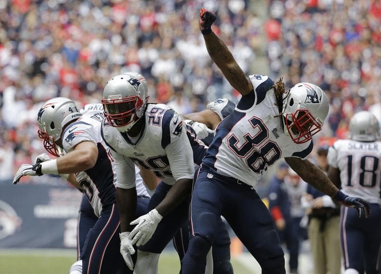New England Patriots' LeGarrette Blount celebrates with teammates James Develin and Brandon Bolden after scoring a touchdown against the Texans during the fourth quarter. (David J. Phillip/AP)