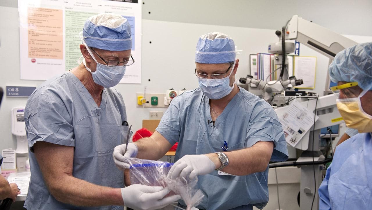 Dr. Elof Eriksson, left, chief of plastic surgery at the Brigham, and Dr. Pomahac prepare the donor tissue during Tarleton's face transplant surgery. (Lightchaser Photography via Brigham and Women’s Hospital)