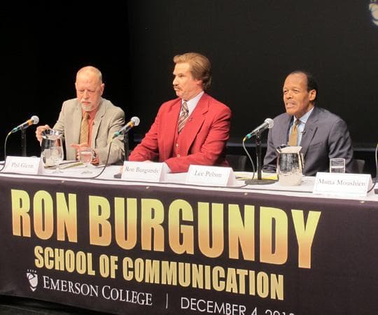 Will Ferrell speaks at a press conference as his character from "Anchorman," Ron Burgundy. Emerson's president, Lee Pelton, is right, while the interim dean of Emerson's School of Communication, Phillip Glenn, is left. (Andrea Shea/WBUR)