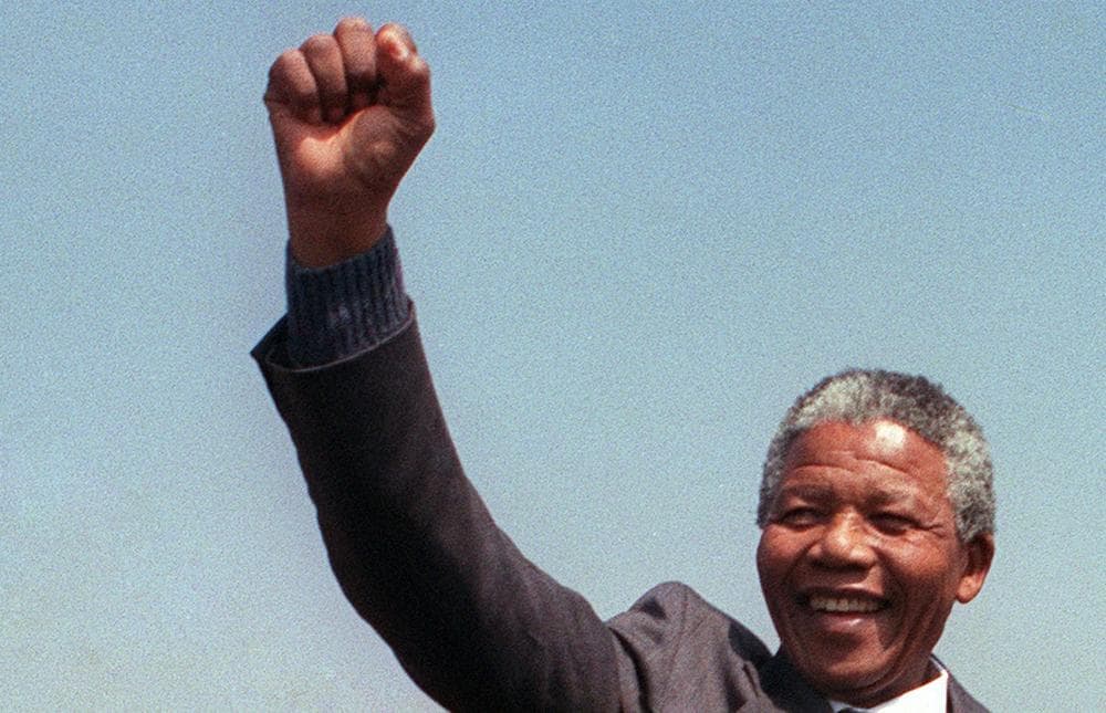 A picture taken on September 5, 1990, shows anti-apartheid leader and African National Congress (ANC) member Nelson Mandela raising fist while addressing in Tokoza a crowd of residents from the Phola park squatter camp during his tour of townships. (Trevor Samson/AFP/Getty Images)