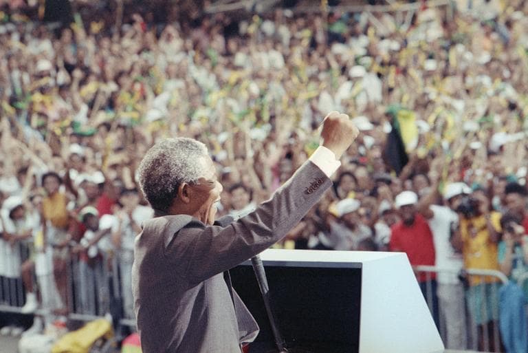 Nelson Mandela salutes the crowd at the Esplanade in Boston on June 23, 1990, where more than 200,000 people gathered to see him. (David Longstreth/AP)