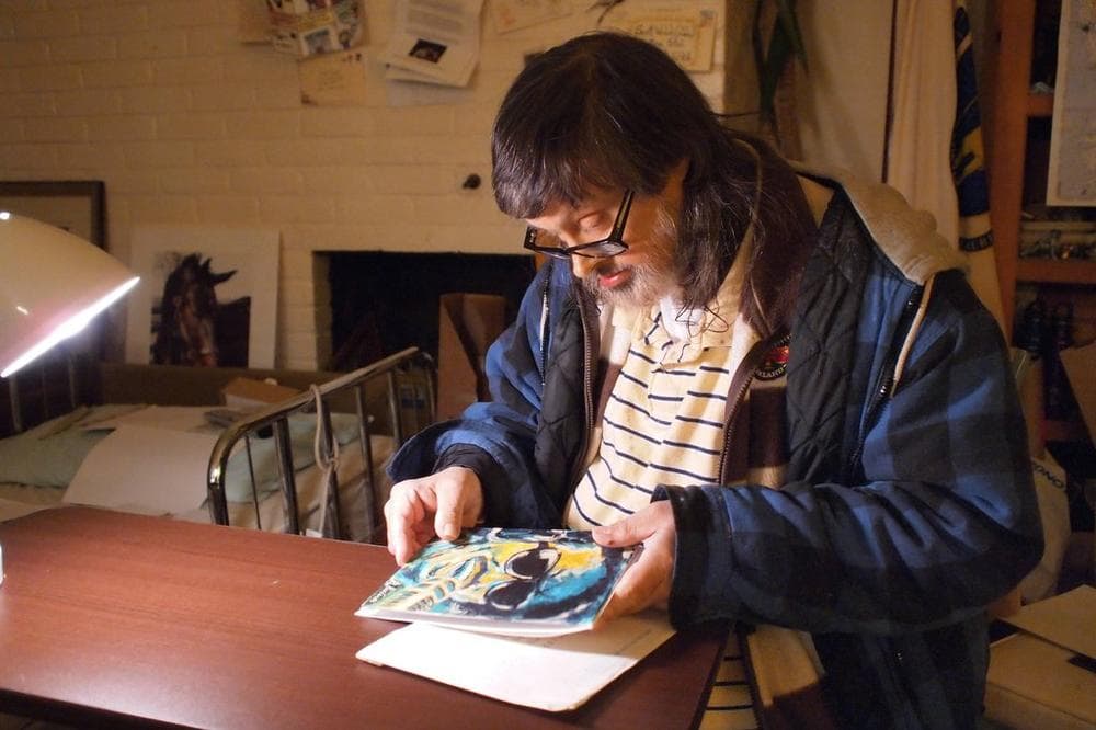 Scott looks at a painting of Stevie Wonder that came in one of his letters. His nephew had listed Stevie Wonder as one of Scott's favorite musicians. (Courtesy)