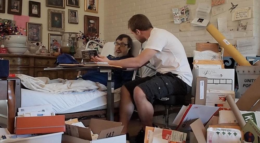 Sean O'Connor sits at his uncle's bedside, surrounded by boxes of mail. (Courtesy) 