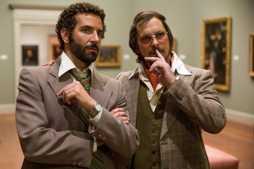 Bradley Cooper (left) as FBI Agent Richie DiMaso in the film, &quot;American Hustle.&quot; Christian Bale, (right) as conman Irving Rosenfeld. (Sony Pictures)