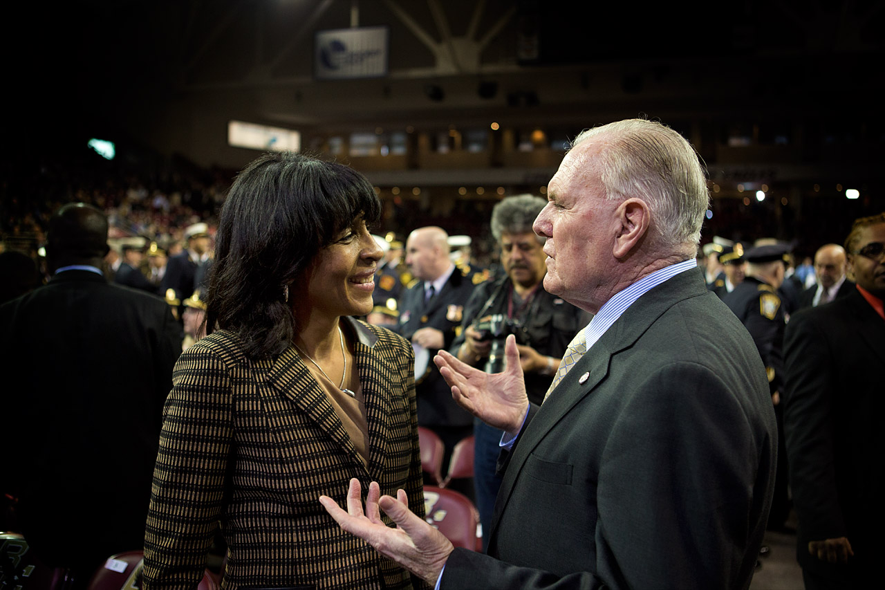 Charlotte Golar Richie and former Boston Mayor Raymond Flynn exchange words before the ceremony. (Jesse Costa/WBUR)
