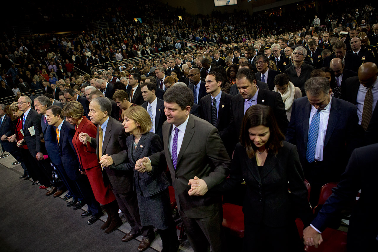 Everyone in the Conte Forum holds hands while the Benediction was read by the Rev. Dr. Ray Hammond. (Jesse Costa/WBUR)