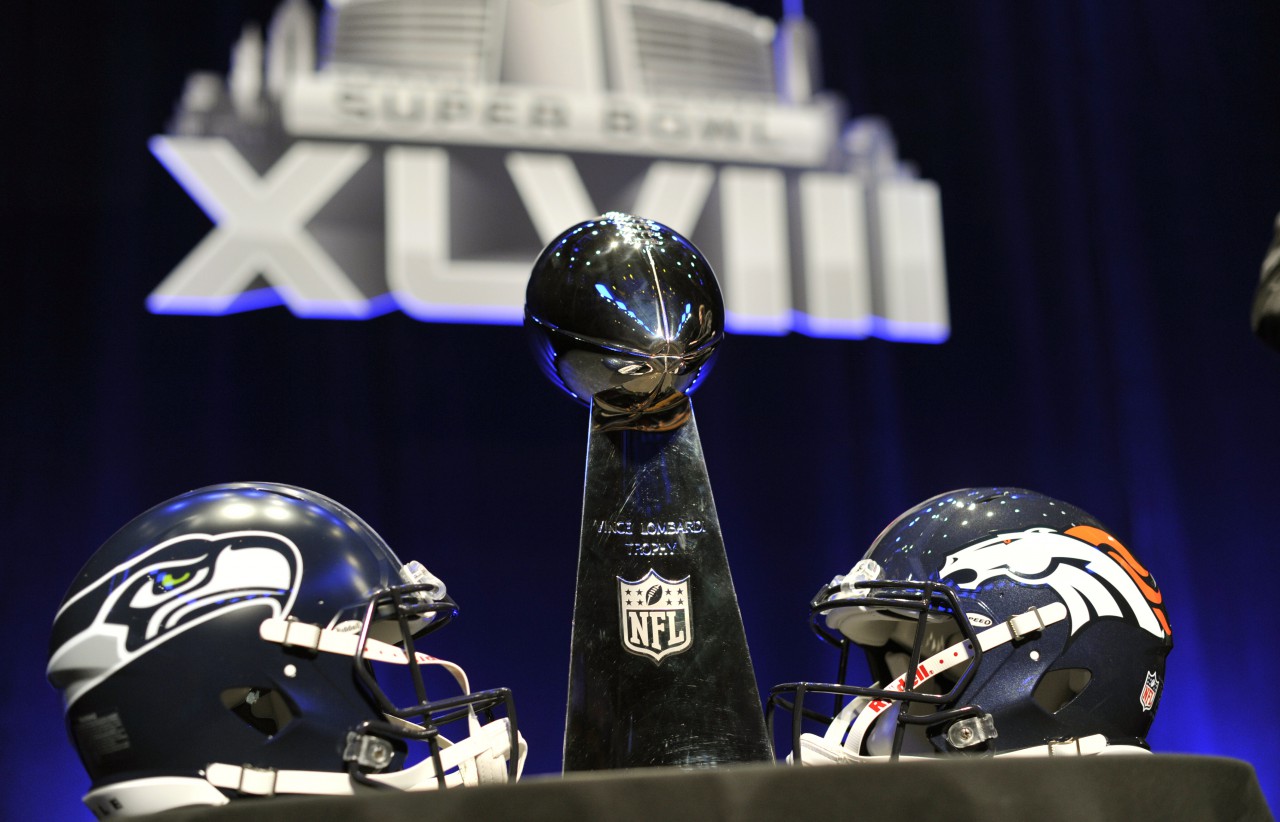 The Vince Lombardi Trophy and helmets for the Seattle Seahawks and Denver Broncos are displayed prior to a Super Bowl XLVIII head coach joint press conference at the Rose Theater in Jazz at Lincoln Center on January 31, 2014 in New York. (Timothy Clary/AFP/Getty Images)