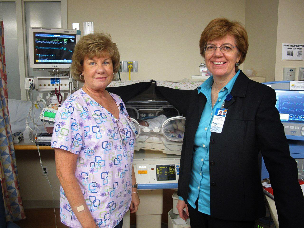 Nurse Linda McAvoy, left, and Dr. Sabrina Craigo in the NICU at Tufts Medical Center's Floating Hospital for Children. (Martha Bebinger/WBUR)
