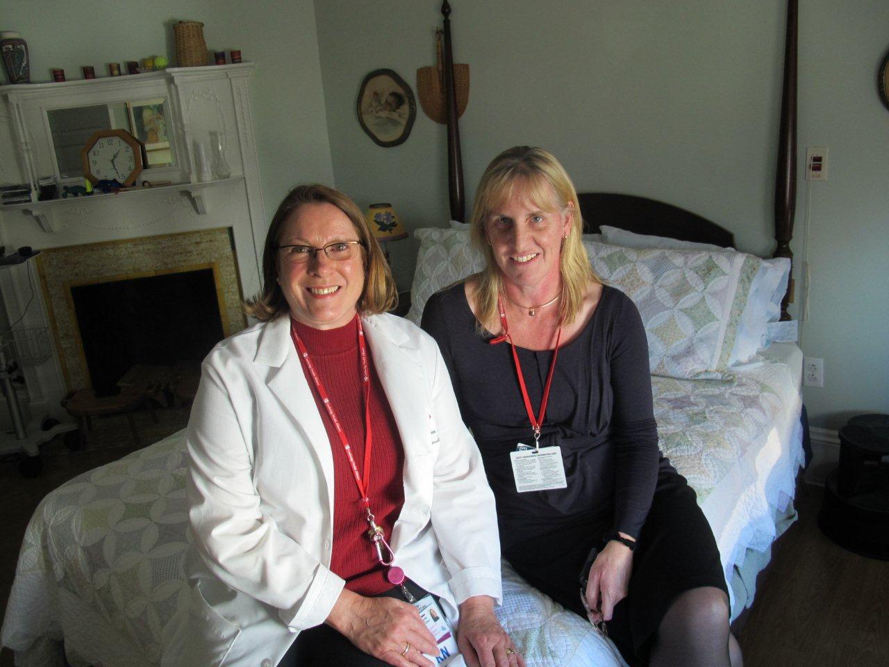 Nurse manager Jessica Buinicki, left, and Dr. Kate Harney sit in the birth center at Cambridge Hospital. (Martha Bebinger/WBUR)