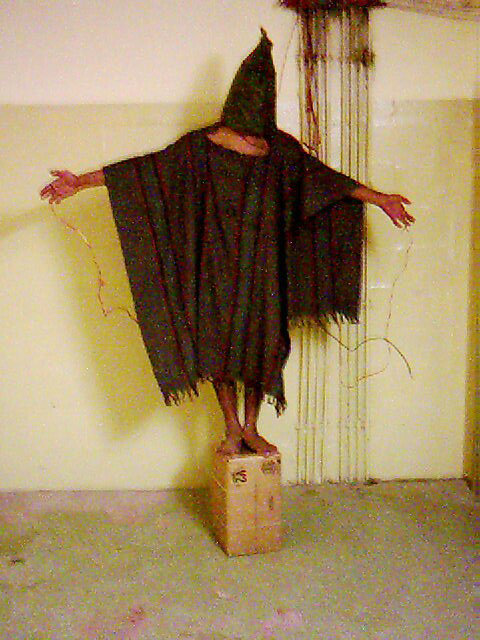 In this late 2003 image, an unidentified detainee stands on a box with a bag on his head and wires attached to him at the Abu Ghraib prison in Baghdad, Iraq. (AP)