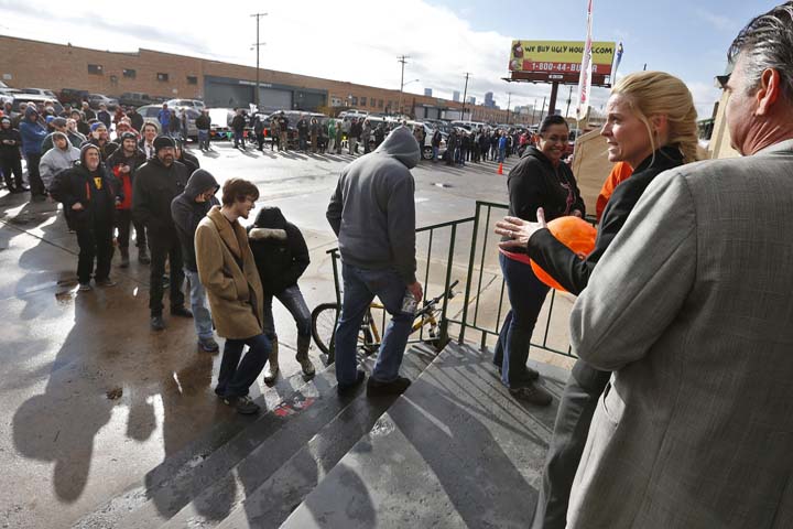 Store owner Toni Fox, second from right, greets customers standing in a snaking line numbering several hundred people shortly after the opening of her 3D Cannabis Center in Denver at 8am on Wednesday Jan. 1, 2014. Colorado began legalized retail recreational marijuana sales on Jan. 1, a day some are calling "Green Wednesday." (AP)