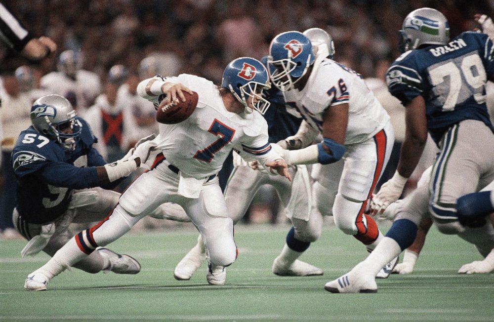 When John Elway quarterbacked the Broncos from 1983 to 1998, Denver and Seattle were AFC West Division rivals. (Barry Sweet/AP)