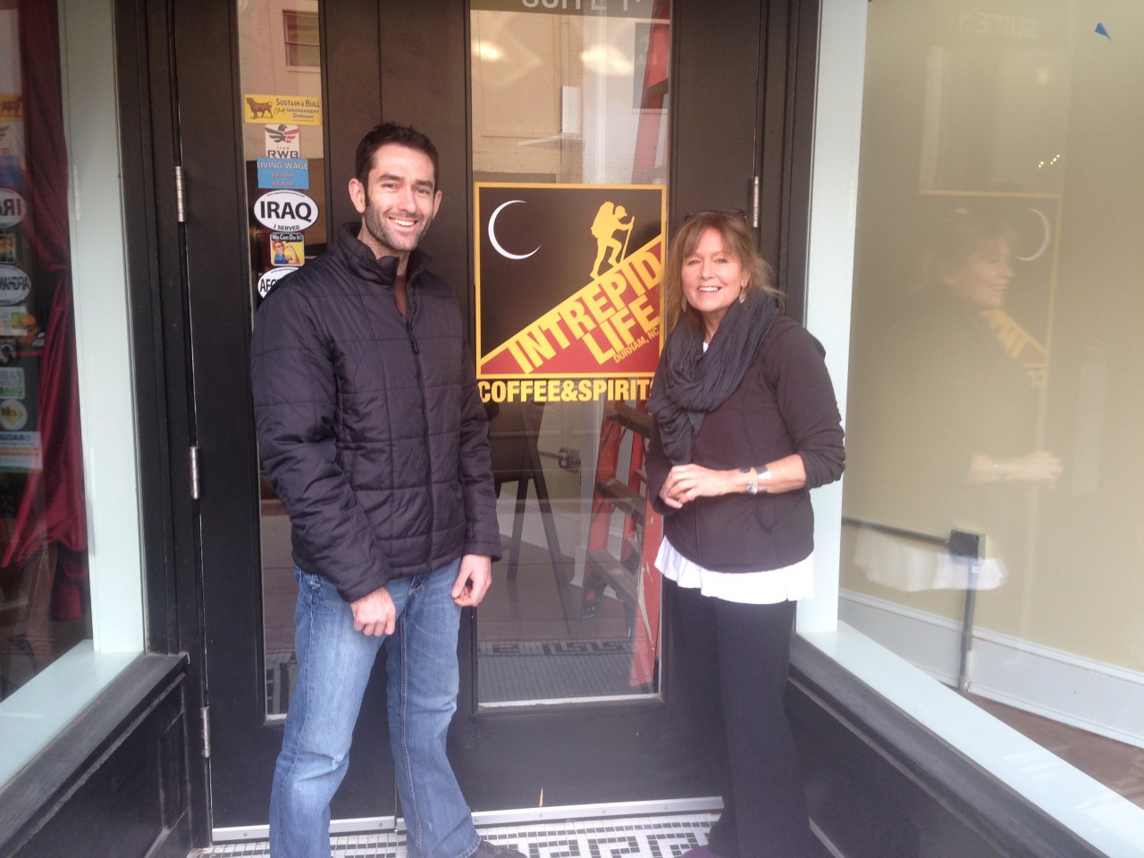 Matt Victoriano and Robin Young pose for a photo in front of Intrepid Life Coffee &amp; Spirits in January 2014. (Robin Young/Here &amp; Now)