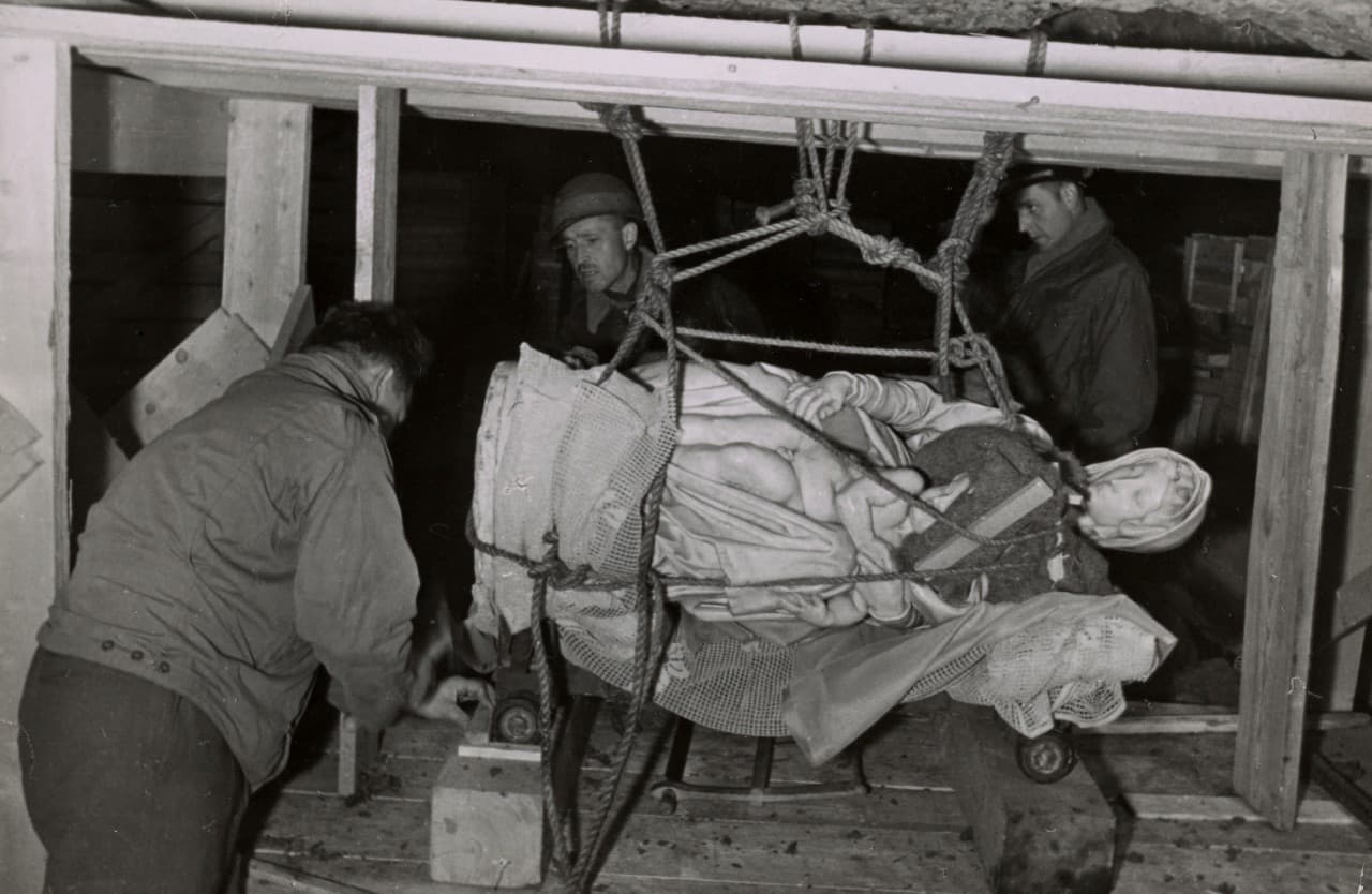 This 1945 handout photo provided by the Smithsonian Institution shows the rescuing of Michelangelo’s Madonna and Child in Altaussee, Austria. Photographs, maps and records from the real corps of soldiers known as “Monuments Men” who were tasked with protecting European cultural sites and recovering looted art during World War II are going on display in Washington, many for the first time. (Smithsonian Institution via AP)