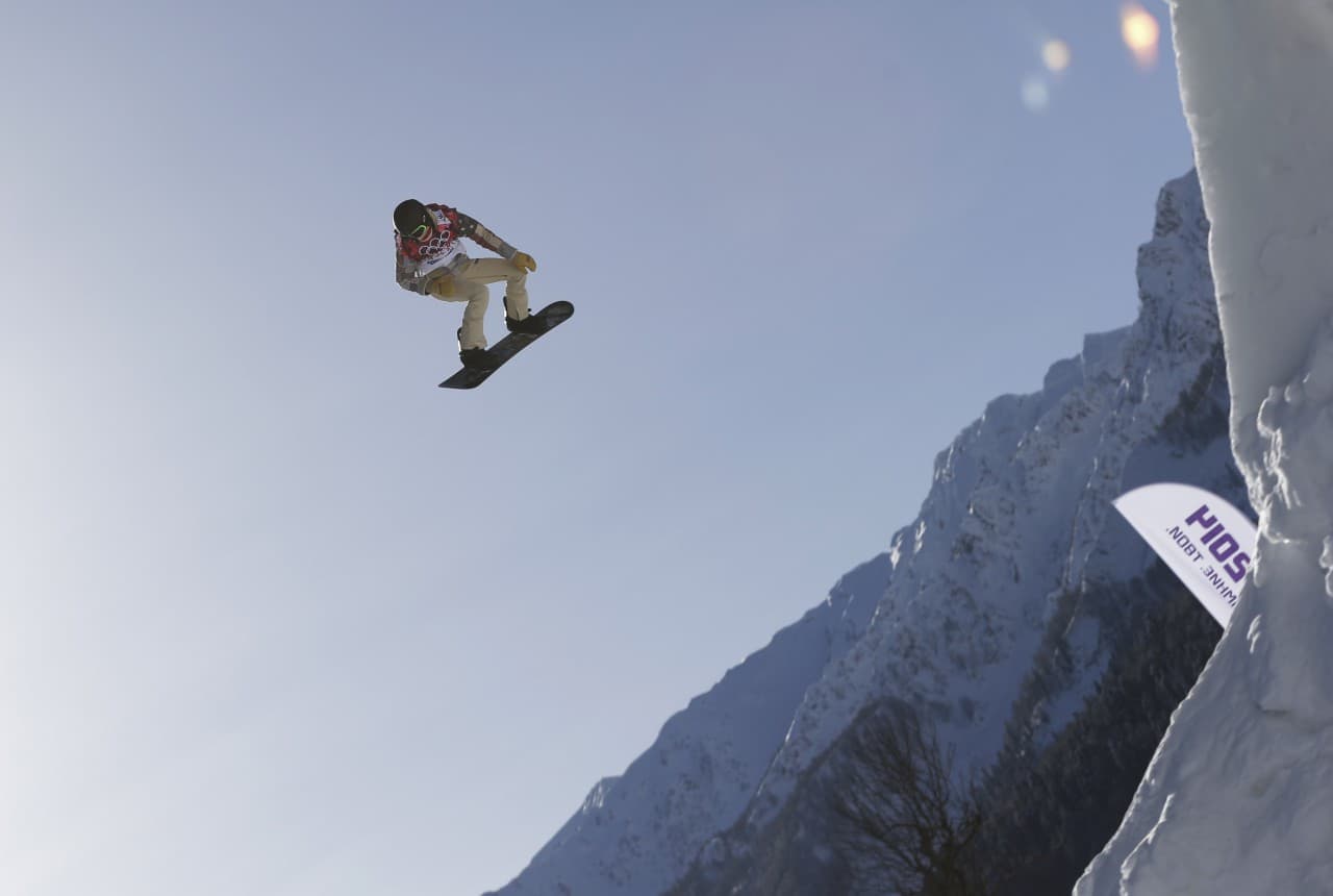 Shaun White of the U.S. takes a jump during a snowboard slopestyle training session, Tuesday, Feb. 4, 2014, in Krasnaya Polyana, Russia. The following day, White announced that he would pull out of the Olympic slopestyle contest to focus solely on winning a third straight gold medal on the halfpipe. (Andy Wong/AP)