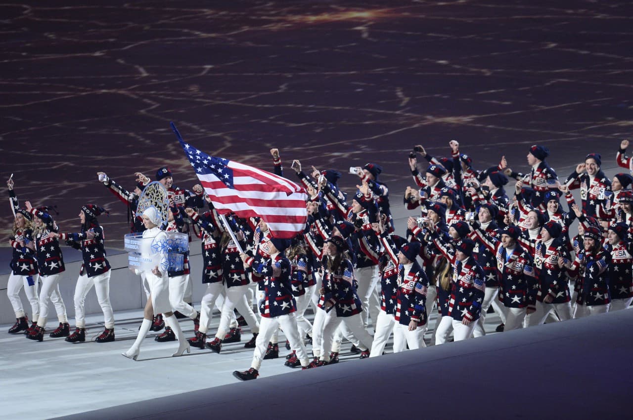 US flag bearer, nordic combined skier Todd Lodwick leads his national delegation. (Jonathan Nackstrand/AFP/Getty Images)