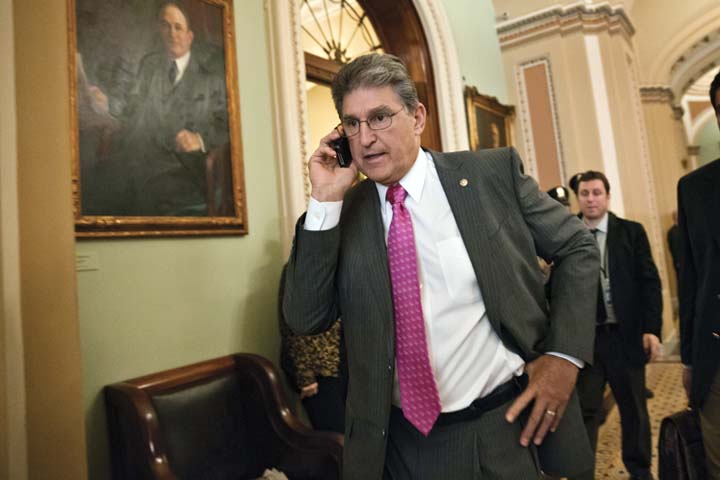 Sen. Joe Manchin, D-W.Va., taks on his phone just off the Senate floor following lunch with fellow Democrats, at the Capitol in Washington, Tuesday, Oct. 15, 2013. His daughter's M.B.A. was determined to have been incorrectly granted in 2008 after a lengthy investigation. (AP)
