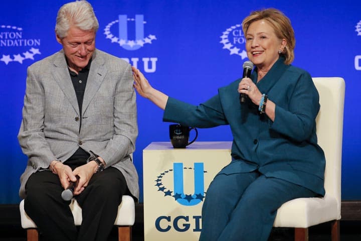 Former President Bill Clinton, left, listens as former Secretary of State Hillary Rodham Clinton speaks during a student conference for the Clinton Global Initiative University, Saturday, March 22, 2014, at Arizona State University in Tempe, Ariz. (AP)
