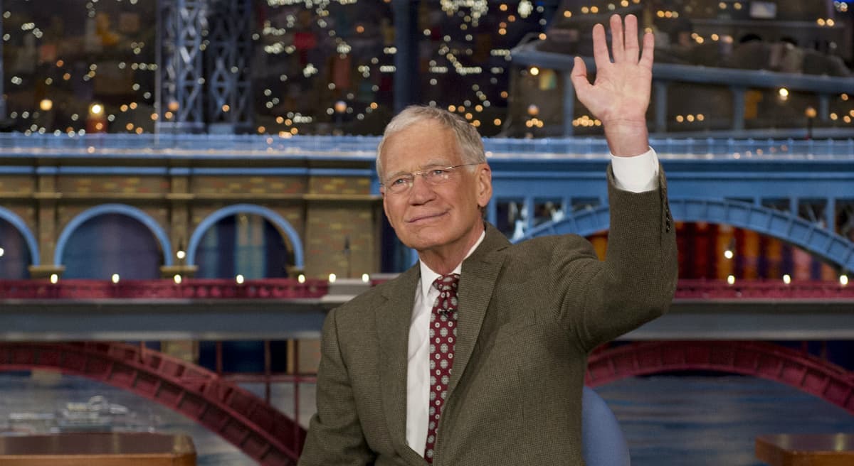 In this photo, David Letterman, host of the “Late Show with David Letterman,” waves to the audience in New York on Thursday, April 3, 2014, after announcing that he will retire sometime in 2015. Letterman, 66, has the longest tenure of any late-night talk show host in U.S. television history, already marking 32 years since he created "Late Night" at NBC in 1982. (Jeffrey R. Staab/AP)