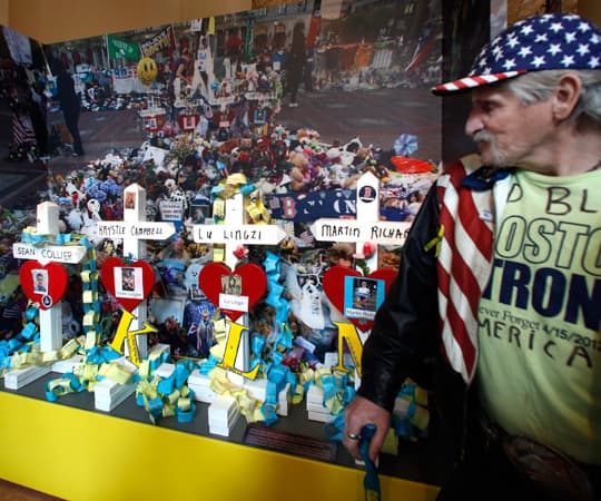 Kevin Brown pauses to look at an exhibit entitled "Dear Boston: Messages from the Marathon Memorial" at the Boston Public Library in Boston, Monday, April 7, 2014. (Elise Amendola/AP)