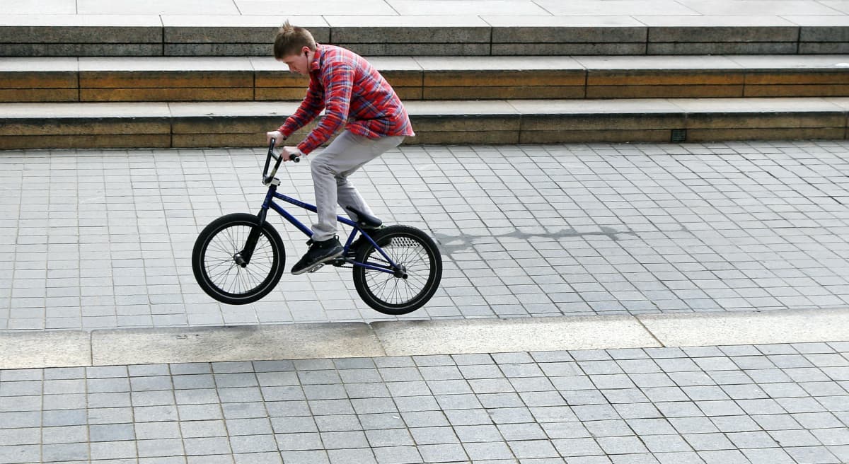 A man rides his bike in downtown Boston on the first day of spring, Thursday, March 20, 2014. (Elise Amendola/AP)