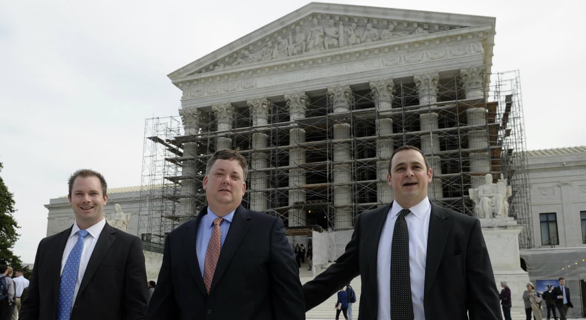 When the unequal influence of rich people is a "fact of life," where's the line between influence and bribery? In this photo, Republican activist Shaun McCutcheon of Hoover, Ala., center, leaves the Supreme Court in Washington, Tuesday, Oct. 8, 2013, after the court's hearing on campaign finance. (Susan Walsh/AP)
