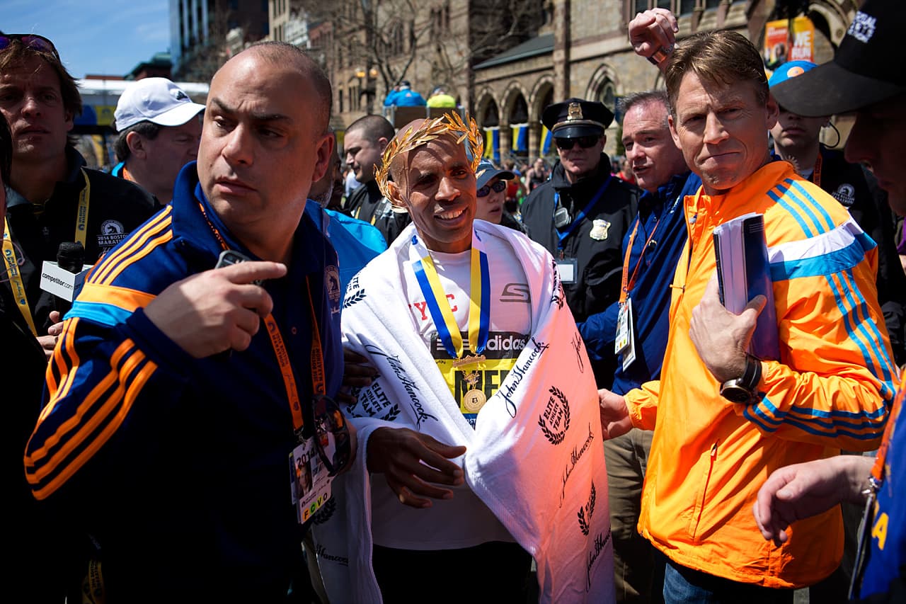 Winner Meb Keflezighi makes his was through the crowd.
