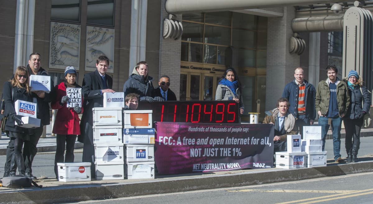 Members of global advocacy group Avaaz stand next to a digital counter showing the number of petition signatures calling for net neutrality outside the Federal Communication Commission in Washington, Thursday, Jan. 30, 2014. Avaaz joined other U.S. advocacy groups to deliver more than a million signatures for a free and democratic internet to the FCC. (Kevin Wolf/AP)