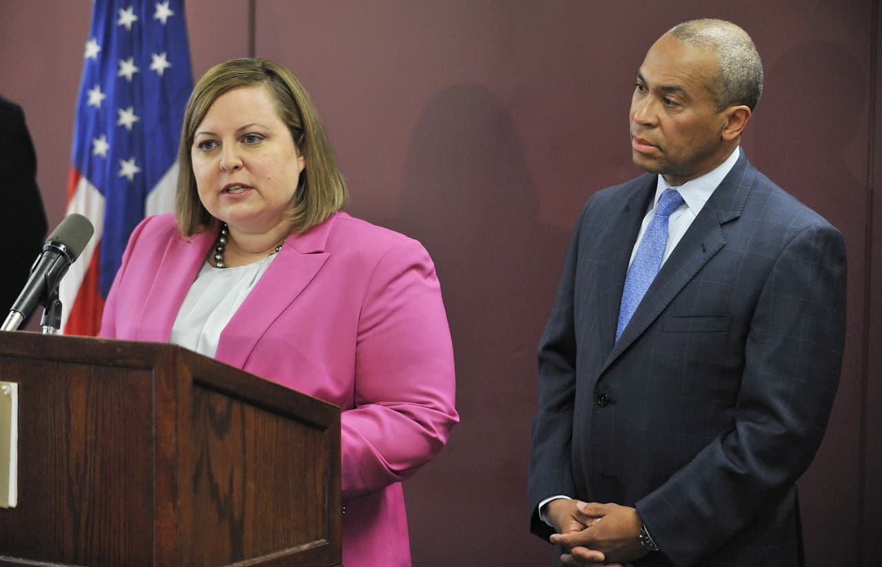 Erin Deveney, interim head of Department of Children and Families, left, speaks as Gov. Deval Patrick, right, stands alongside at a news conference Tuesday, April 29, 2014 in Boston. (Josh Reynolds/AP)