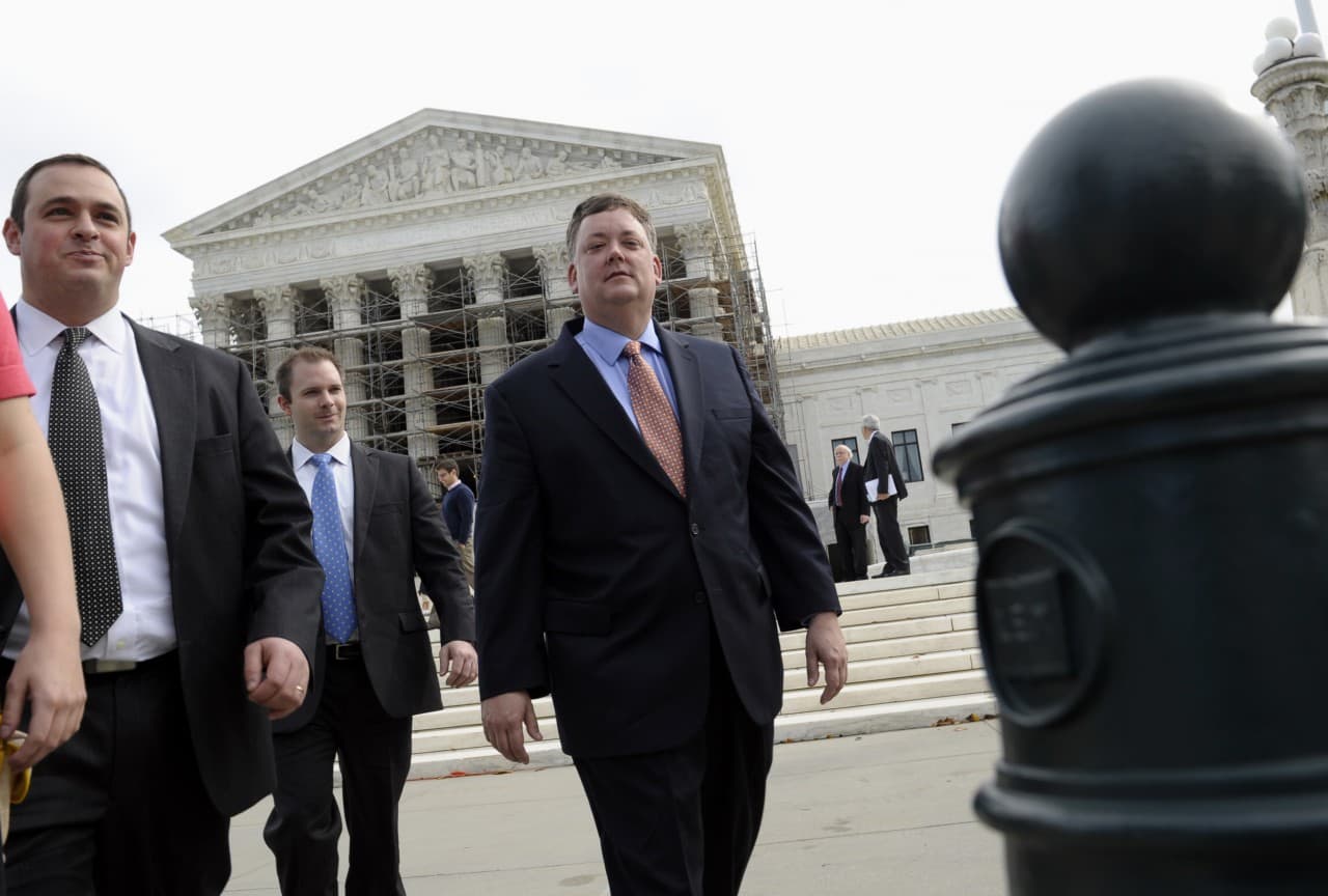 Republican activist Shaun McCutcheon of Hoover, Ala., right, leaves the Supreme Court in Washington, Tuesday, Oct. 8, 2013, after the court's hearing on campaign finance. (Susan Walsh/AP) 
