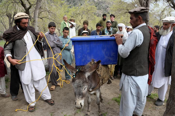 Afghan election workers carry ballot boxes and election materials on donkeys to deliver to polling stations in Dara-e-Noor district of Jalalabad, east of Kabul, Afghanistan, Friday, April 4, 2014. (AP)