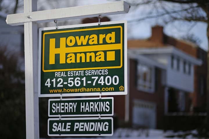 In this Thursday, Jan. 9, 2014, photo, a for sale sign with a sale pending hangs in front of a house in Mount Lebanon, Pa. The National Association of Realtors reports on the number of Americans who signed contracts to buy homes in December on Thursday, Jan. 30, 2014.  (AP)