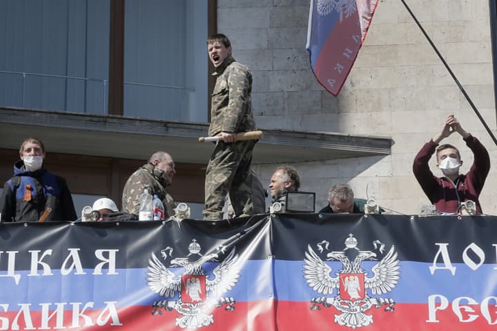 Pro-Russian activists shout during a rally at the regional administration building in Donetsk, Ukraine, Tuesday, April 8, 2014, as the makings of an improved self-appointed government began to take shape, with demonstrators dug in for their third day at the 11-storey regional administration headquarters. (AP)